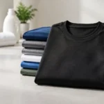 Black and colorful T-shirts arranged to illustrate how to prevent shirts from fading